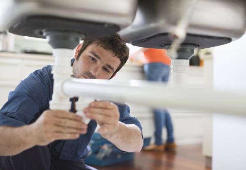 Plumber Repairing a Leak